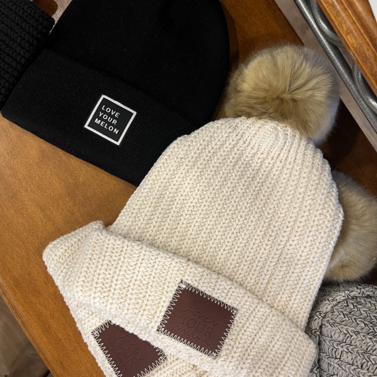 BLACK AND WHITE LOVE YOUR MELON HATS IN THE BOUTIQUE AT BLUE HARBOR RESORT