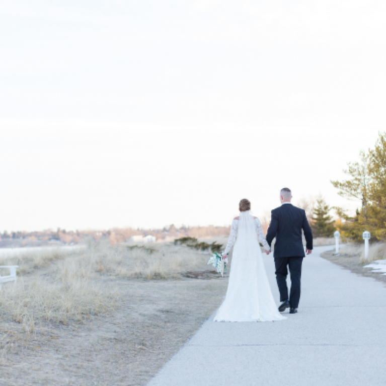 BRIDE AND GROOM ON BEACH BOARDWALK AT BLUE HARBOR RESORT WEDDING