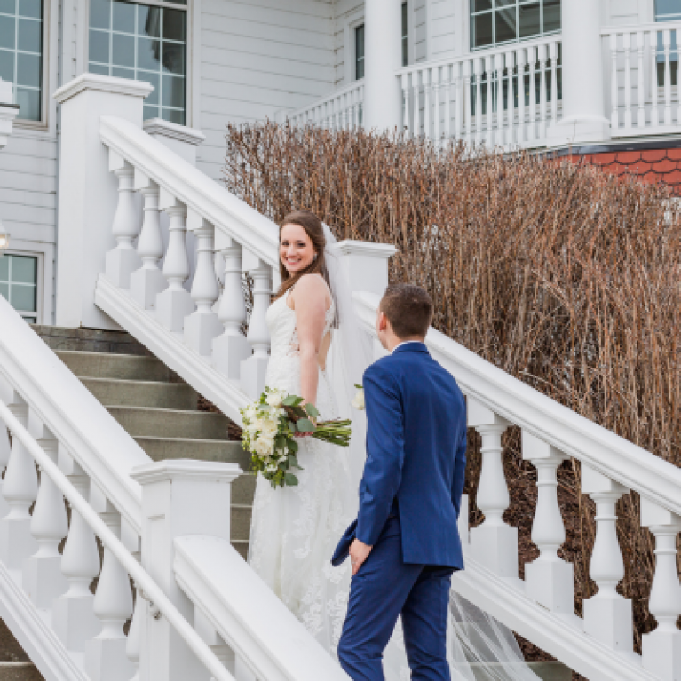 BRIDE AND GROOM ON STAIRCASE AT BLUE HARBOR RESORT WEDDING