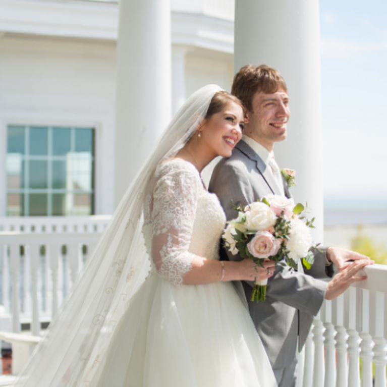 BRIDE AND GROOM OVERLOOKING LAKE MICHIGAN AT BLUE HARBOR RESORT WEDDING