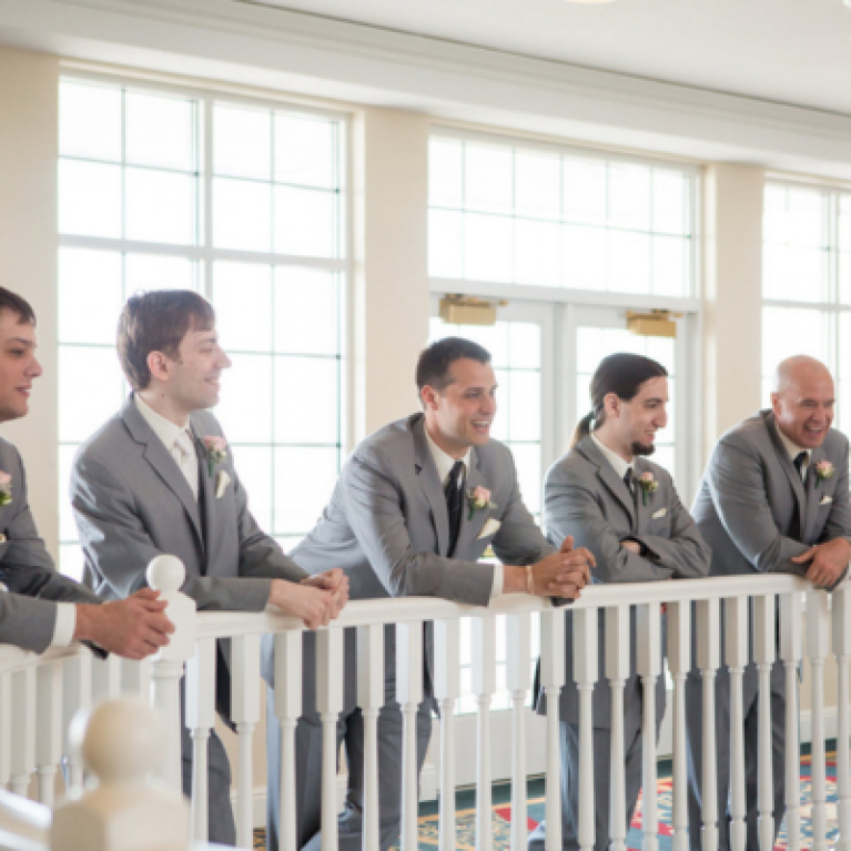 GROOMSMEN ON BALCONY AT BLUE HARBOR RESORT WEDDING